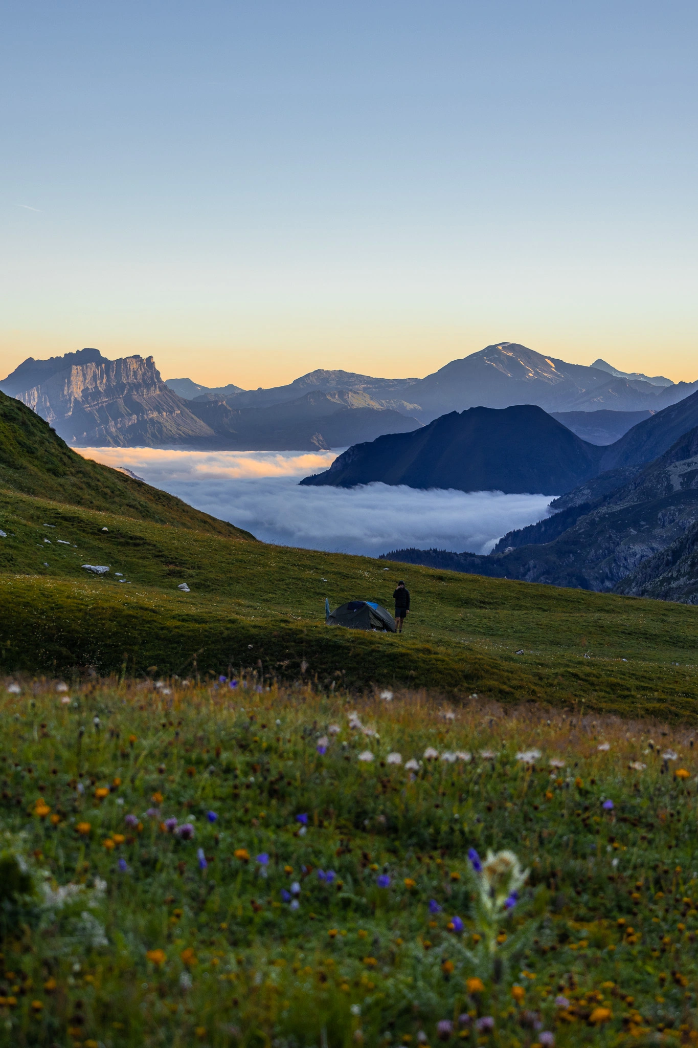 photo d'une tente dans un alpage avec un couché de soleil